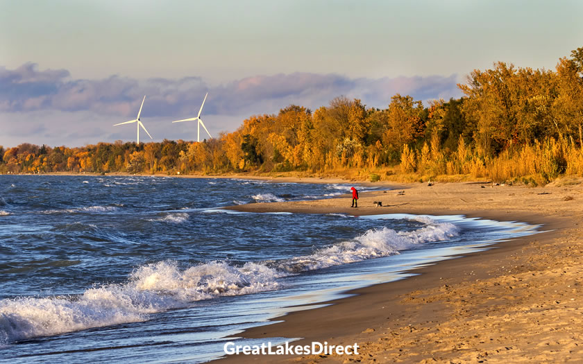 
Woman walking a dog on a beach near Grand Bend
